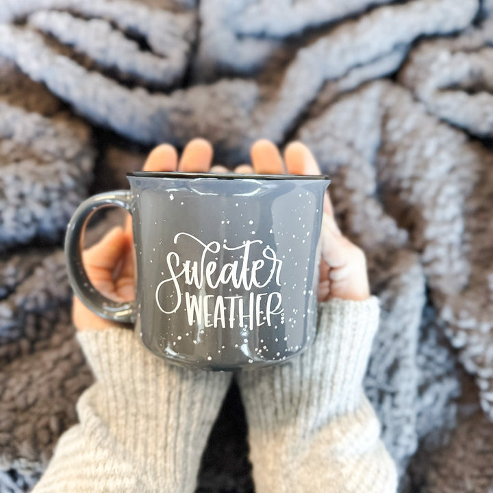 sweather weather ceramic mug being held